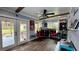 Game room with bar, patio access, and ceiling fan at 14636 Bray Rd, Orlando, FL 32832