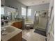 Primary bathroom with double vanity, soaking tub, and shower at 148 Joewood Trl, Davenport, FL 33837