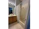 Bathroom with tub shower combo, single vanity, and tile floor at 148 Joewood Trl, Davenport, FL 33837
