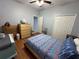 Bedroom with a queen bed and light wood floors at 148 Joewood Trl, Davenport, FL 33837