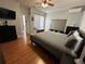 Bright bedroom with king bed, wood floors, and access to a patio at 148 Joewood Trl, Davenport, FL 33837