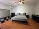 Spacious bedroom with king-size bed, ample closet space, and wood flooring at 148 Joewood Trl, Davenport, FL 33837
