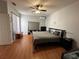 King-size bed, wood floors, and plenty of natural light in this bedroom at 148 Joewood Trl, Davenport, FL 33837