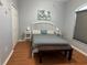 Cozy bedroom with a queen bed, and wood flooring at 148 Joewood Trl, Davenport, FL 33837