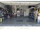 Well-organized garage with various storage solutions and flooring at 148 Joewood Trl, Davenport, FL 33837