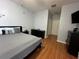 Main bedroom with king-size bed and hardwood floors at 148 Joewood Trl, Davenport, FL 33837
