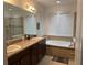 Bathroom with double vanity, soaking tub, and shower at 15043 Pigeon Plum Ln, Winter Garden, FL 34787