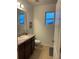 Bathroom with sink, toilet, and mirror at 15043 Pigeon Plum Ln, Winter Garden, FL 34787