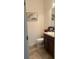 Clean bathroom with dark vanity and tile floors at 15043 Pigeon Plum Ln, Winter Garden, FL 34787