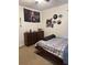 Bedroom with double bed, dresser, and wall art at 15043 Pigeon Plum Ln, Winter Garden, FL 34787