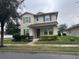 Two-story house with neutral siding, shutters, and landscaping at 15043 Pigeon Plum Ln, Winter Garden, FL 34787