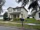 Two-story house with neutral siding, shutters, and landscaping at 15043 Pigeon Plum Ln, Winter Garden, FL 34787