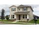 Two-story house with neutral siding, shutters, and landscaping at 15043 Pigeon Plum Ln, Winter Garden, FL 34787