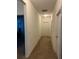 Simple hallway with neutral colored carpet at 15043 Pigeon Plum Ln, Winter Garden, FL 34787