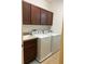 Laundry room with washer, dryer, and cabinets at 15043 Pigeon Plum Ln, Winter Garden, FL 34787