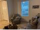 Living room with gray recliner, sofa, and coffee table at 15043 Pigeon Plum Ln, Winter Garden, FL 34787
