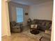 Living room with gray recliner, sofa, and coffee table at 15043 Pigeon Plum Ln, Winter Garden, FL 34787
