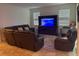 Living room featuring a sectional sofa and entertainment center at 15043 Pigeon Plum Ln, Winter Garden, FL 34787
