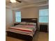 Main bedroom with king-size bed and two nightstands at 15043 Pigeon Plum Ln, Winter Garden, FL 34787