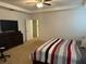 Main bedroom with a dresser, TV, and ensuite bathroom at 15043 Pigeon Plum Ln, Winter Garden, FL 34787