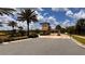 Gated community entrance with guard house and landscaping at 1515 Carey Palm Cir, Kissimmee, FL 34747