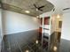 Open concept living area with dark tile floors and exposed ceilings at 155 S Court Ave # 1603, Orlando, FL 32801