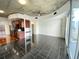 Open concept living area with dark tile floors and exposed ceilings at 155 S Court Ave # 1603, Orlando, FL 32801