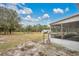 Large backyard with mature trees and a screened porch at 1960 Murray Rd, Fort Meade, FL 33841