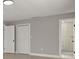 Simple bedroom with gray walls, white doors and en-suite bath at 202 Cobalt Dr, Kissimmee, FL 34758