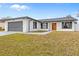 Updated single story home with gray garage door and orange front door at 202 Cobalt Dr, Kissimmee, FL 34758