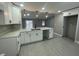 Modern white kitchen with island, quartz countertops, and black hardware at 202 Cobalt Dr, Kissimmee, FL 34758