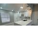 Bright kitchen features white cabinets, quartz countertops, and pendant lighting at 202 Cobalt Dr, Kissimmee, FL 34758
