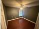 Dark-walled bedroom with hardwood floors and ceiling fan at 224 Greenwich St, Davenport, FL 33896