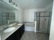 Primary bathroom with double vanity, garden tub, and separate shower at 228 Whispering Pines Way, Davenport, FL 33837