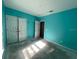 Spacious bedroom with light teal walls and double door closet at 228 Whispering Pines Way, Davenport, FL 33837