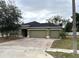 Newly constructed home with a two-car garage and a well-maintained lawn at 228 Whispering Pines Way, Davenport, FL 33837