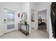 Bright and airy entryway with mirror and console table at 2461 Reading Trl, Kissimmee, FL 34746