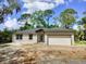Charming single-story home with a two-car garage and neutral color palette on a sunny day at 2531 Buena Vista Dr, Deland, FL 32724
