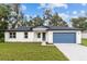 Charming single-story home boasting a blue garage door, freshly landscaped yard, and inviting curb appeal at 2531 Buena Vista Dr, Deland, FL 32724