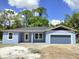 Charming single-story home featuring a covered entryway, an attached garage, and large windows at 2535 Buena Vista Dr, Deland, FL 32724