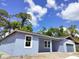 A quaint single-Gathering home featuring light blue siding, an attached garage, and a cozy front porch at 2535 Buena Vista Dr, Deland, FL 32724