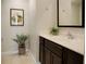 A powder room features a large sink with dark cabinets and tiled floors at 2717 Coupe St, Kissimmee, FL 34746