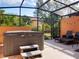 Relaxing hot tub on a screened-in patio, perfect for outdoor enjoyment and relaxation at 2717 Coupe St, Kissimmee, FL 34746