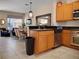 A bright kitchen has light wood cabinets, stainless appliances, and a view to the dining and living area at 2717 Coupe St, Kissimmee, FL 34746