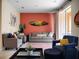 Cozy living room featuring an accent wall, comfortable seating, and a sliding door to the outdoor space at 2717 Coupe St, Kissimmee, FL 34746