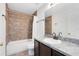 Bathroom with tub, toilet and dark brown vanity at 2717 Shelby Ruth Pl, St Cloud, FL 34769