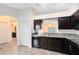 Modern kitchen featuring dark cabinets and stainless steel appliances at 2717 Shelby Ruth Pl, St Cloud, FL 34769
