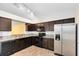 Modern kitchen with stainless steel appliances and dark wood cabinets at 2717 Shelby Ruth Pl, St Cloud, FL 34769