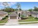 One-story house with a two-car garage and a landscaped yard at 296 Del Sol Ave, Davenport, FL 33837