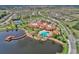 Aerial view of community with resort-style pool, tennis courts, and clubhouse at 296 Del Sol Ave, Davenport, FL 33837